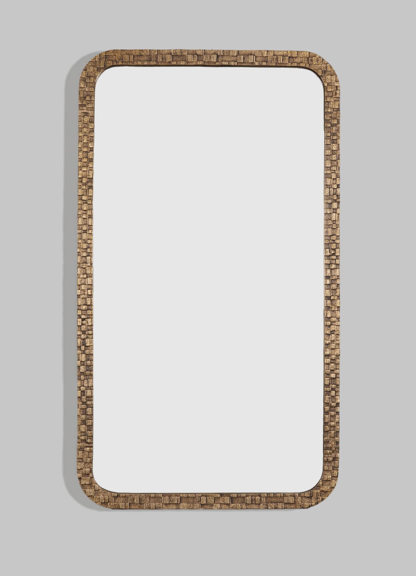 Wooden-framed mirror with a textured, mosaic-style border in a warm brown tone, mounted on a light gray wall.