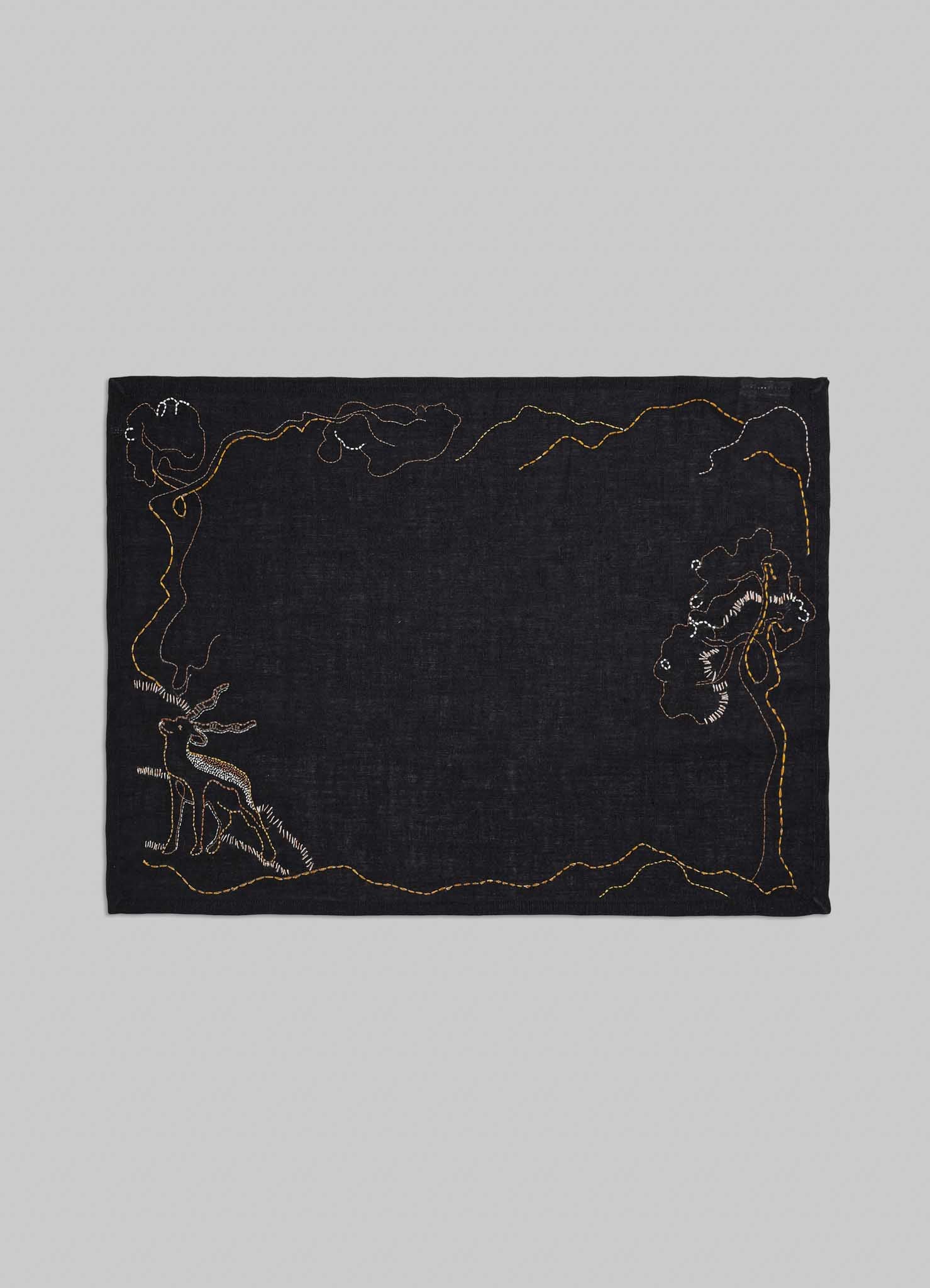 Black fabric with embroidered designs on a gray background placemats viya