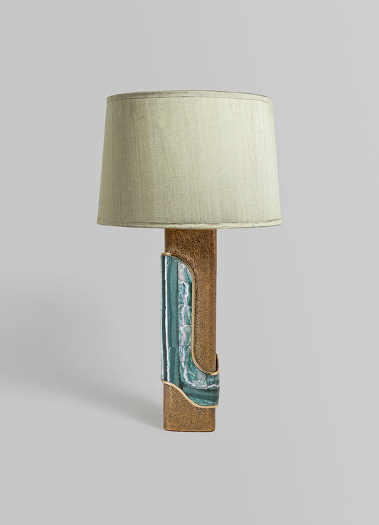 A table lamp with a beige fabric shade and a textured brown ceramic base featuring diagonal inlays of green and blue marbled pattern with gold accents, in a modern style.