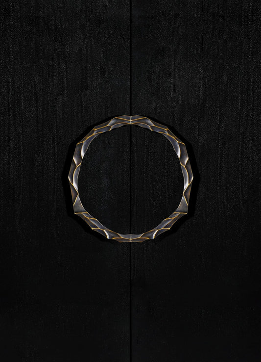 A circular decorative mirror with a wavy, metallic gold frame mounted on a black textured wall. The mirror's design has an abstract, contemporary style.