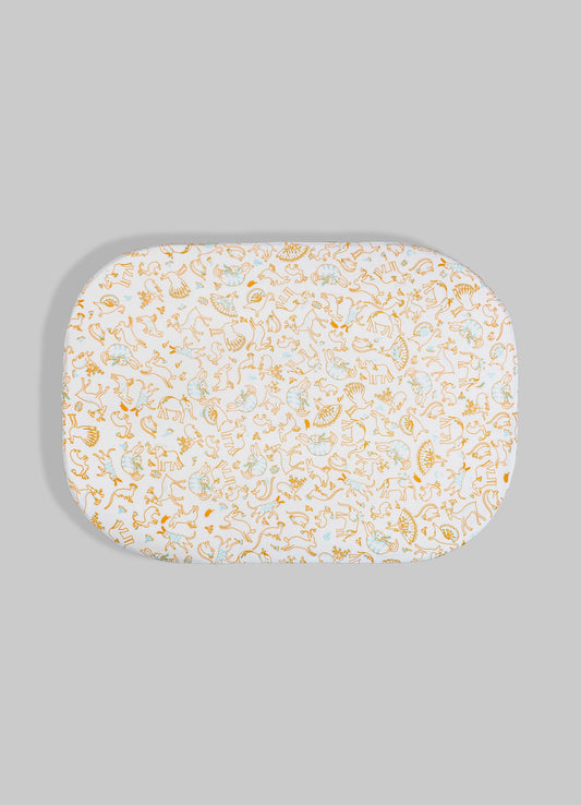 Oval fabric tray with a printed motif of abstracted animals and geometric shapes in soft pastel tones, set against a gray background. The design features a subtle combination of orange and light blue on a white base, giving a contemporary and playful appearance.