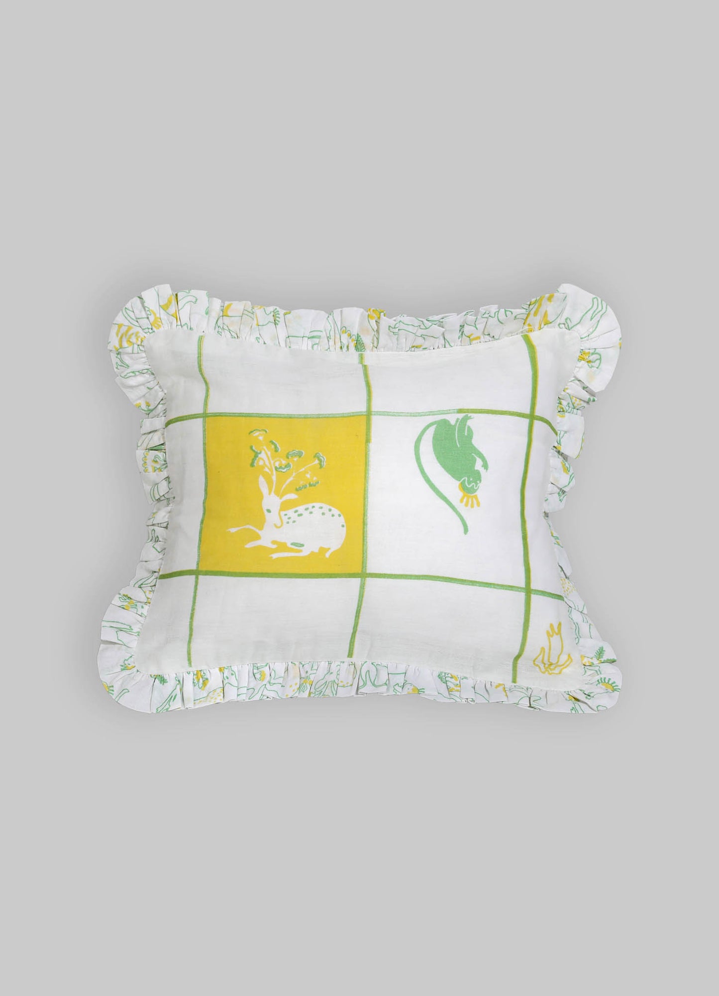 Rectangular decorative pillow with a white cotton cover featuring a green and yellow grid pattern and simplified animal motifs, edged with a ruffled trim made from matching fabric.
