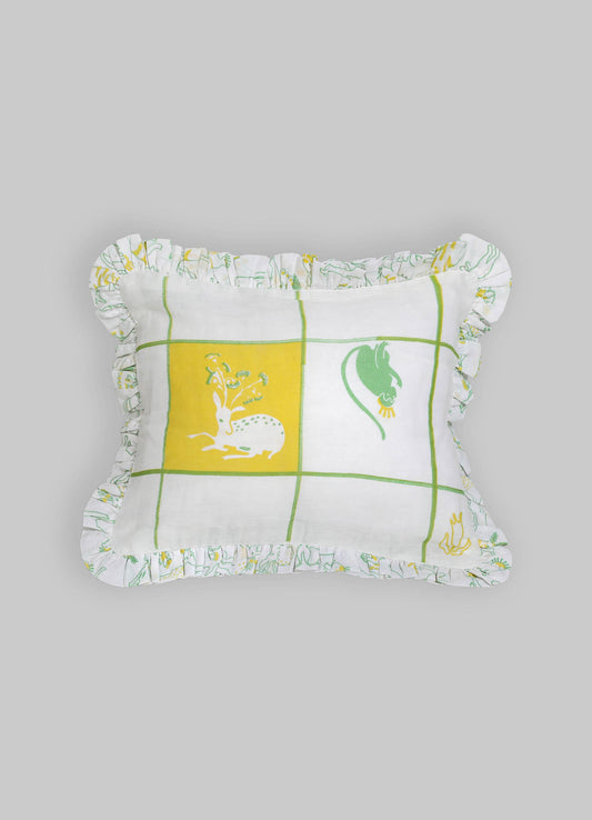 Rectangular decorative pillow with a white cotton cover featuring a green and yellow grid pattern and simplified animal motifs, edged with a ruffled trim made from matching fabric.