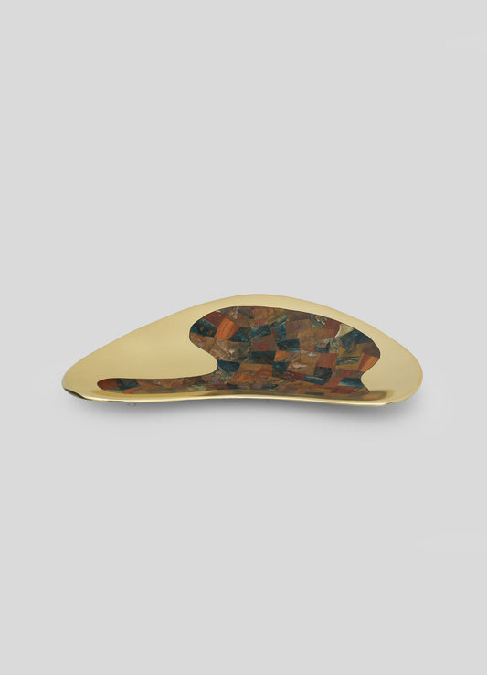 A decorative tray with a metallic gold finish and an irregular, organic shape, featuring a central inlay of multicolored stone mosaic in earthy tones.