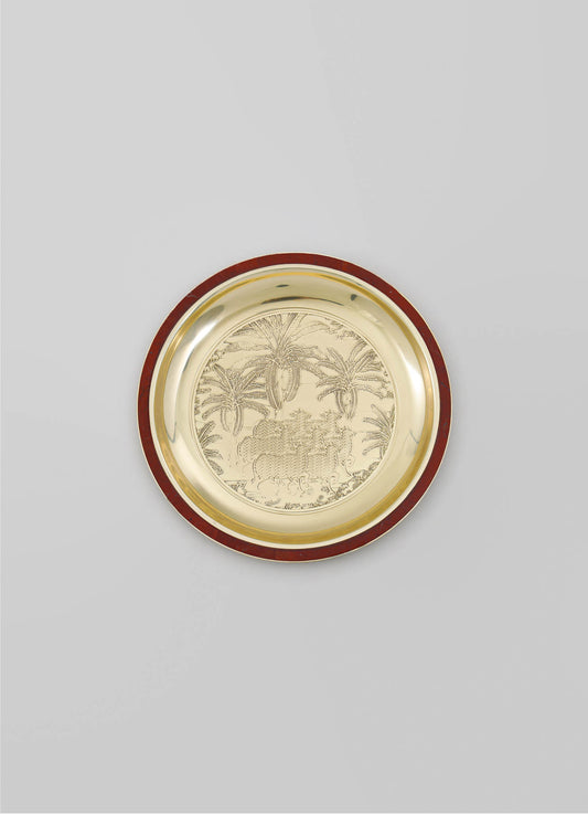 Decorative gold tray with engraved tropical palm tree design, featuring a red border and a polished surface.