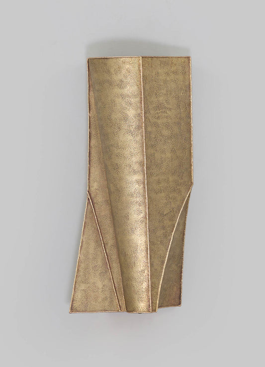 Gold-toned metal wall sconce with a textured leaf-like pattern, featuring a sculptural geometric design for a contemporary aesthetic.