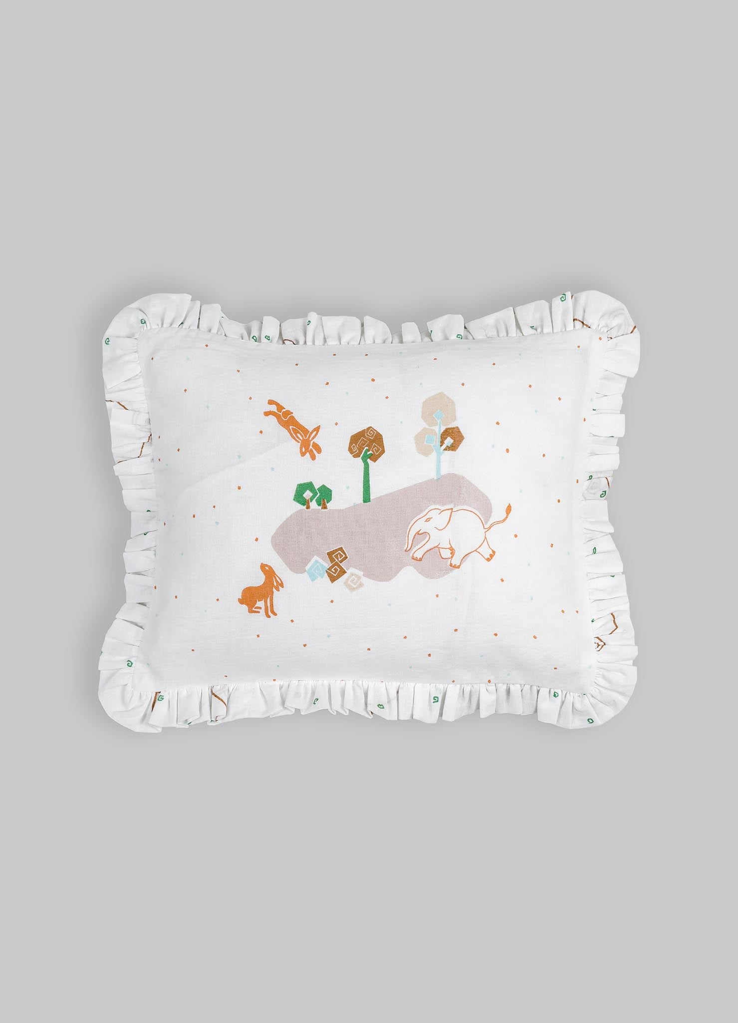 Cotton decorative pillow with embroidered animal motifs and a ruffled border, featuring a playful scene with an elephant, a rabbit, and trees in soft earth tones and pastel shades.