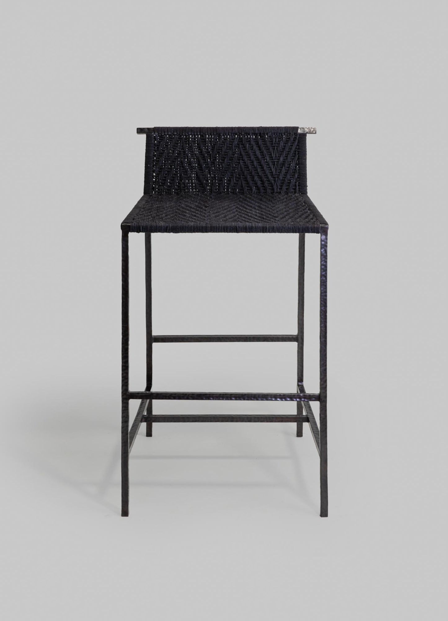 Black woven chair with a textured, geometric pattern on the woven material and a metal frame, set against a plain background.