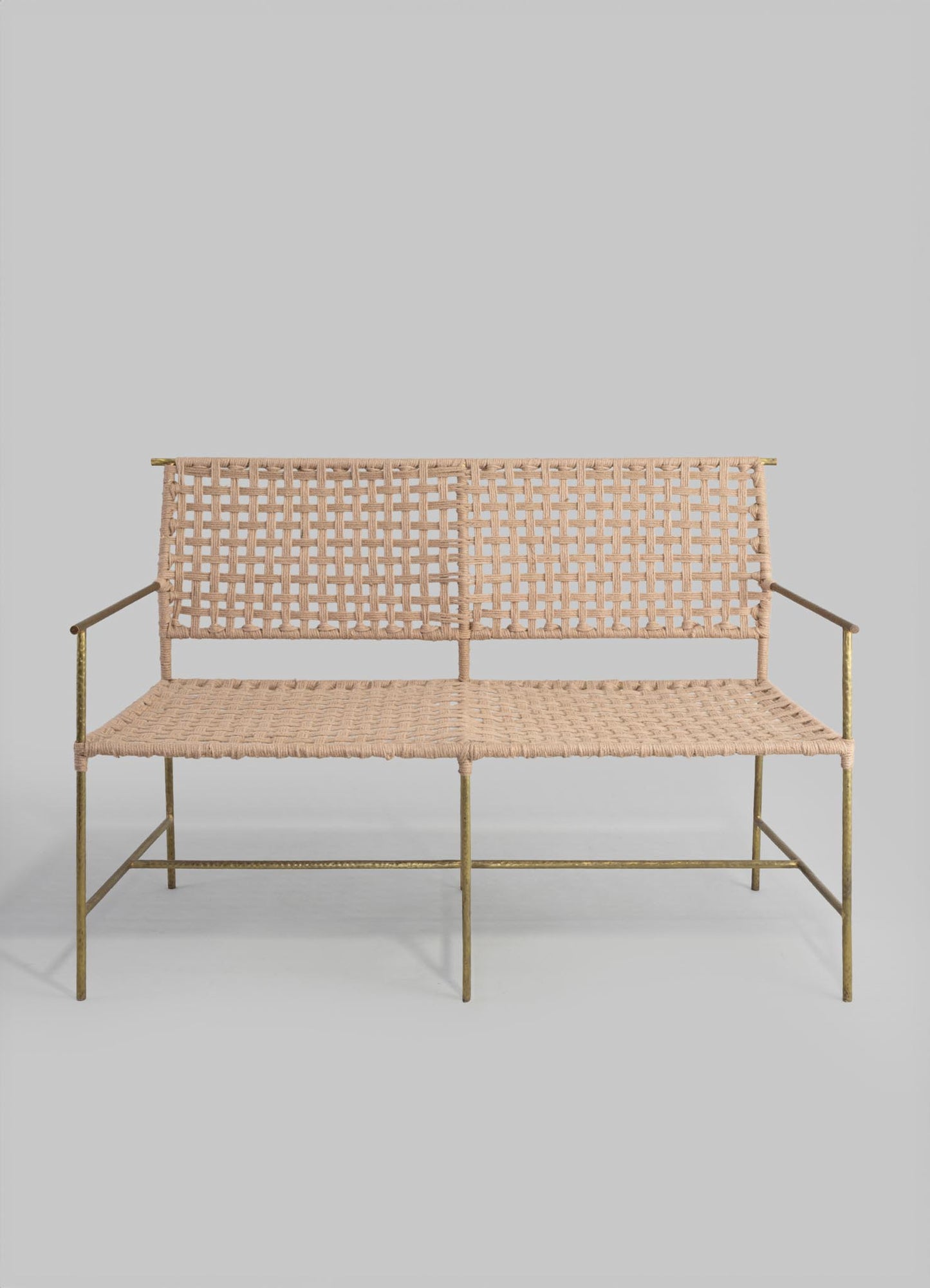 A sofa with a metal frame and woven rattan or wicker seat and backrest, featuring a light beige or natural color palette, designed in a minimalist or contemporary style with clean lines.