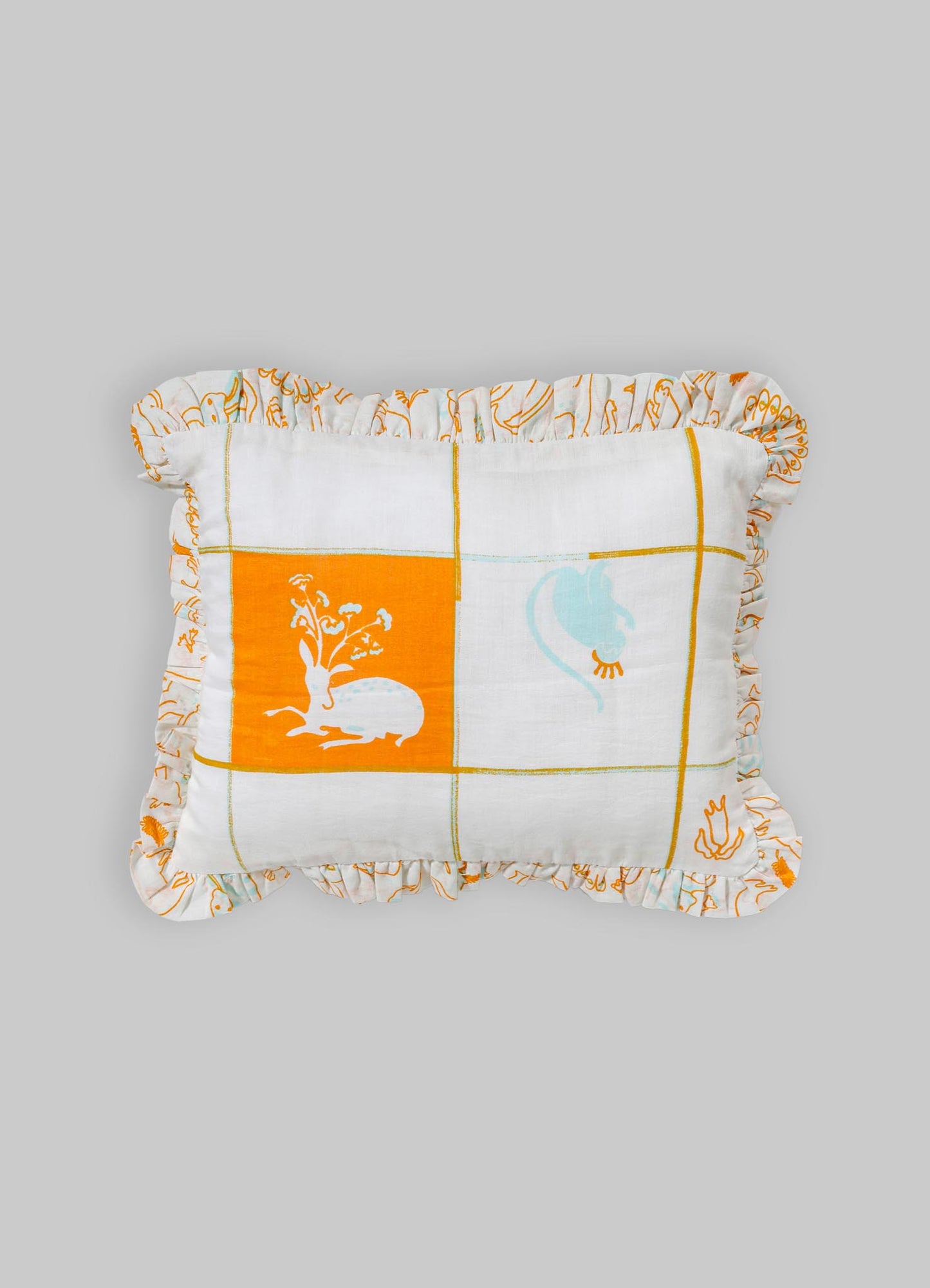 A decorative cushion made of lightweight fabric with a patchwork design featuring orange, white, and blue hues. The cushion has a ruffled border with embroidered patterns and a central motif of a rabbit and floral elements.