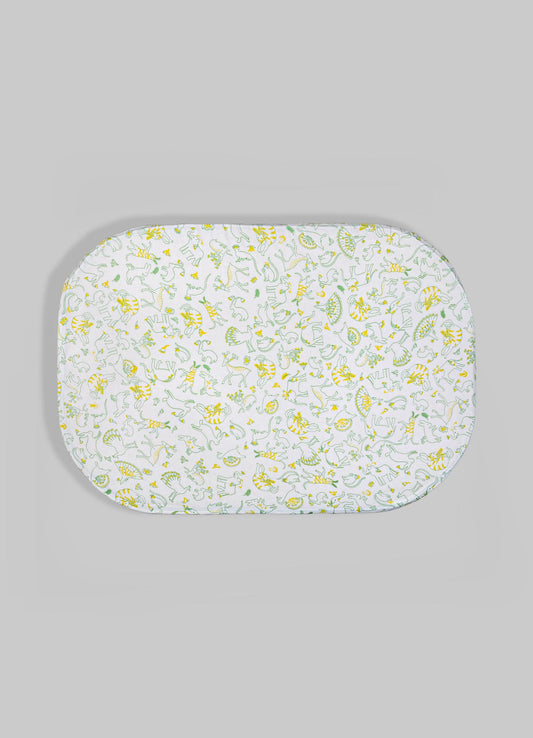 Oval fabric tray with a white base and a colorful animal motif pattern in yellow and green, set against a light gray background.