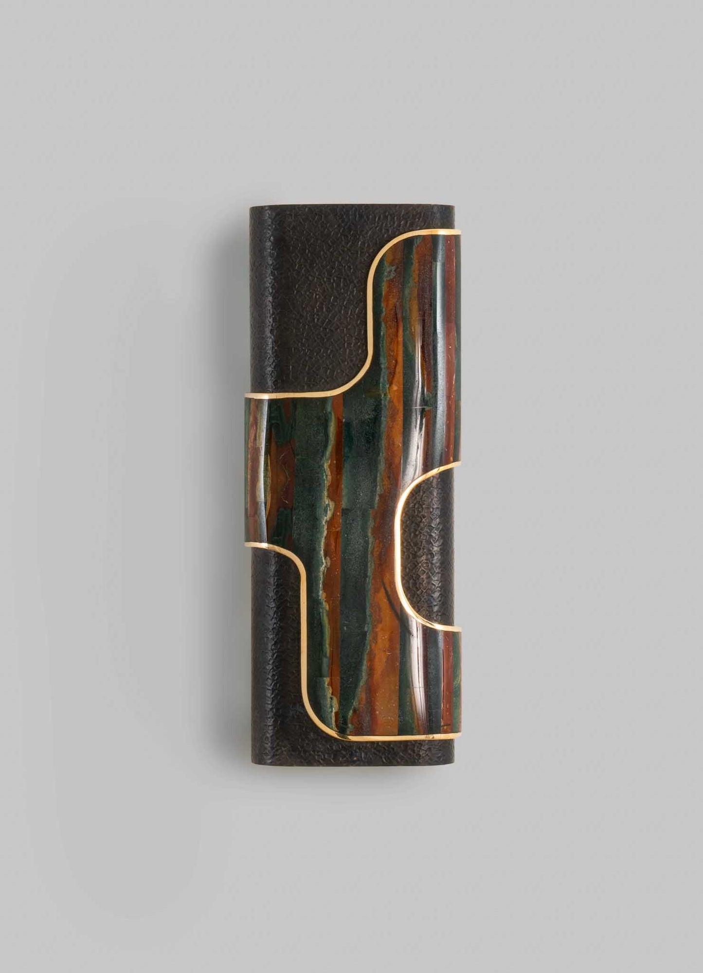 A decorative wall sconce with a cylindrical black textured base, featuring a colorful stone or ceramic insert with green, orange, and brown tones. The design is accentuated by gold-colored metal outlines that create a geometric pattern, giving it a contemporary and artisanal appearance.