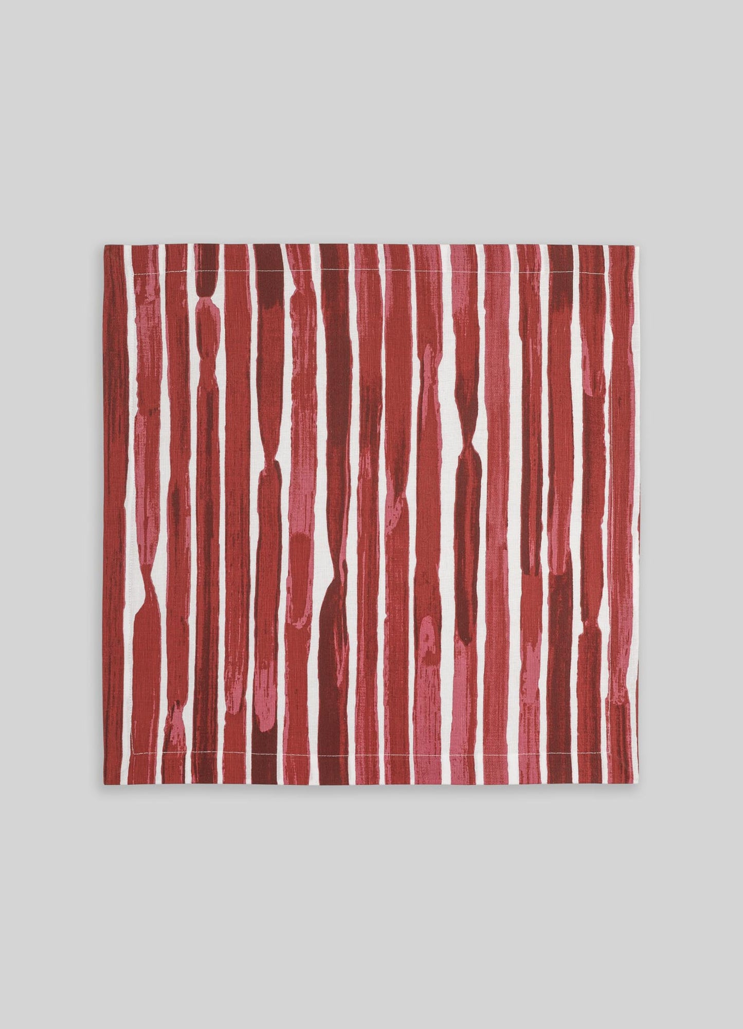 A rectangular fabric with vertical brushstroke pattern in shades of red, pink, and white. The design has an abstract, hand-painted look, suitable for use as a textile or decorative piece.