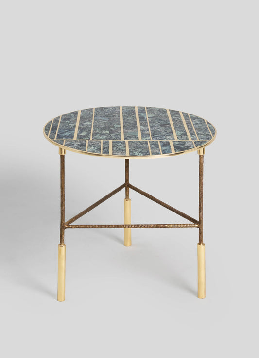 A round side table with a mosaic glass top featuring shades of blue and green, framed by a gold metal edge. The table has a textured bronze-finished metal tripod base with gold accents on the legs.