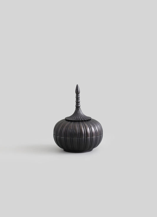 A black, lacquered wooden container with a rounded, ribbed body and a tall, pointed lid featuring stacked rings and a finial, styled in a traditional or handcrafted aesthetic.