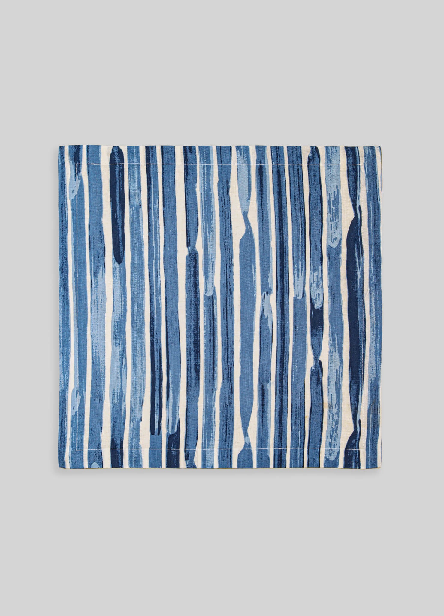 Printed fabric with vertical blue and white brushstroke patterns, likely made of cotton or linen, designed for home decor or textile applications.