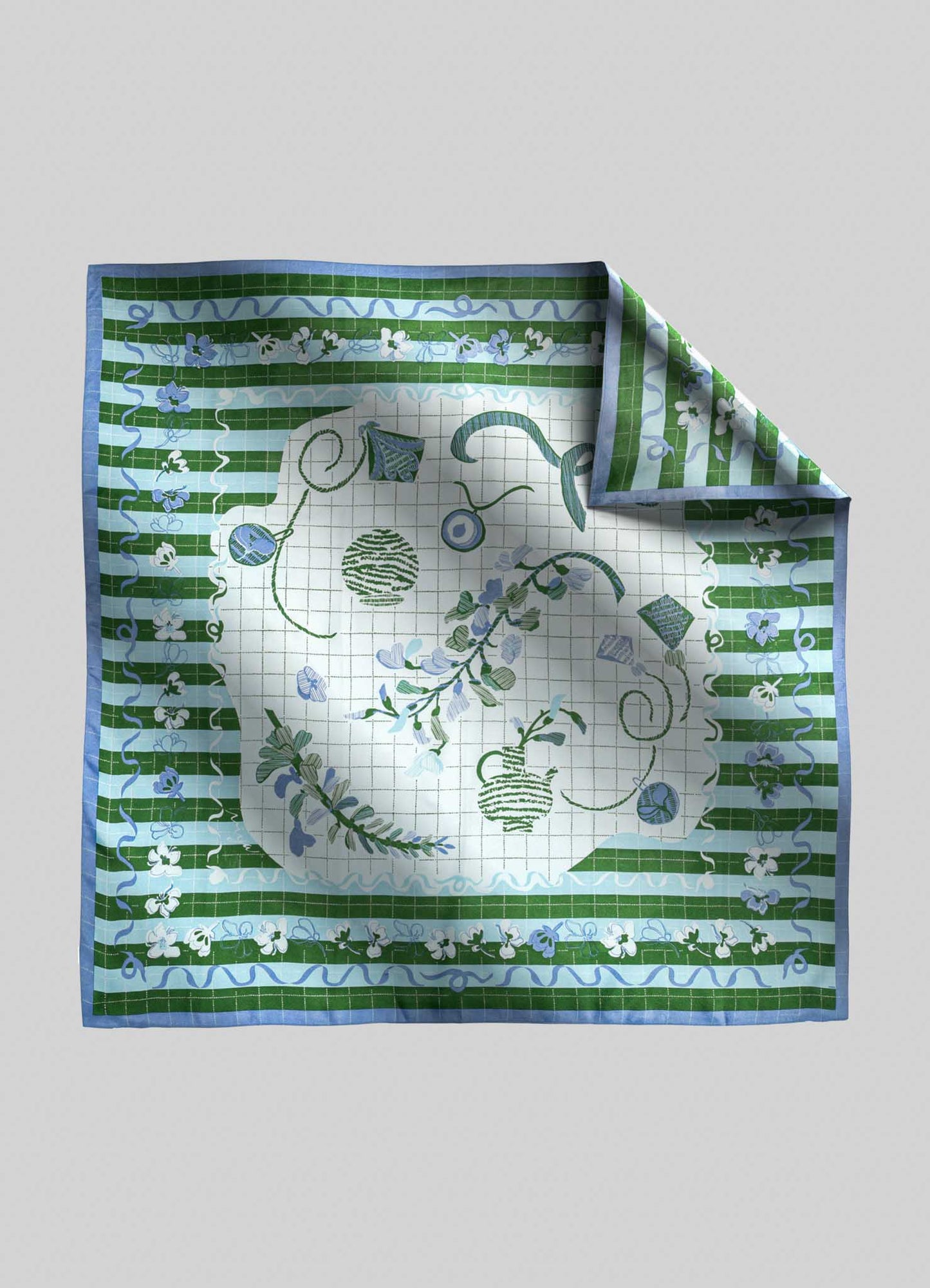 A square handkerchief featuring a floral and geometric pattern in shades of green, blue, and white, with a central motif of stylized plants and abstract shapes. The fabric appears to be lightweight cotton or linen, with a decorative border and a folded corner revealing the underside pattern.