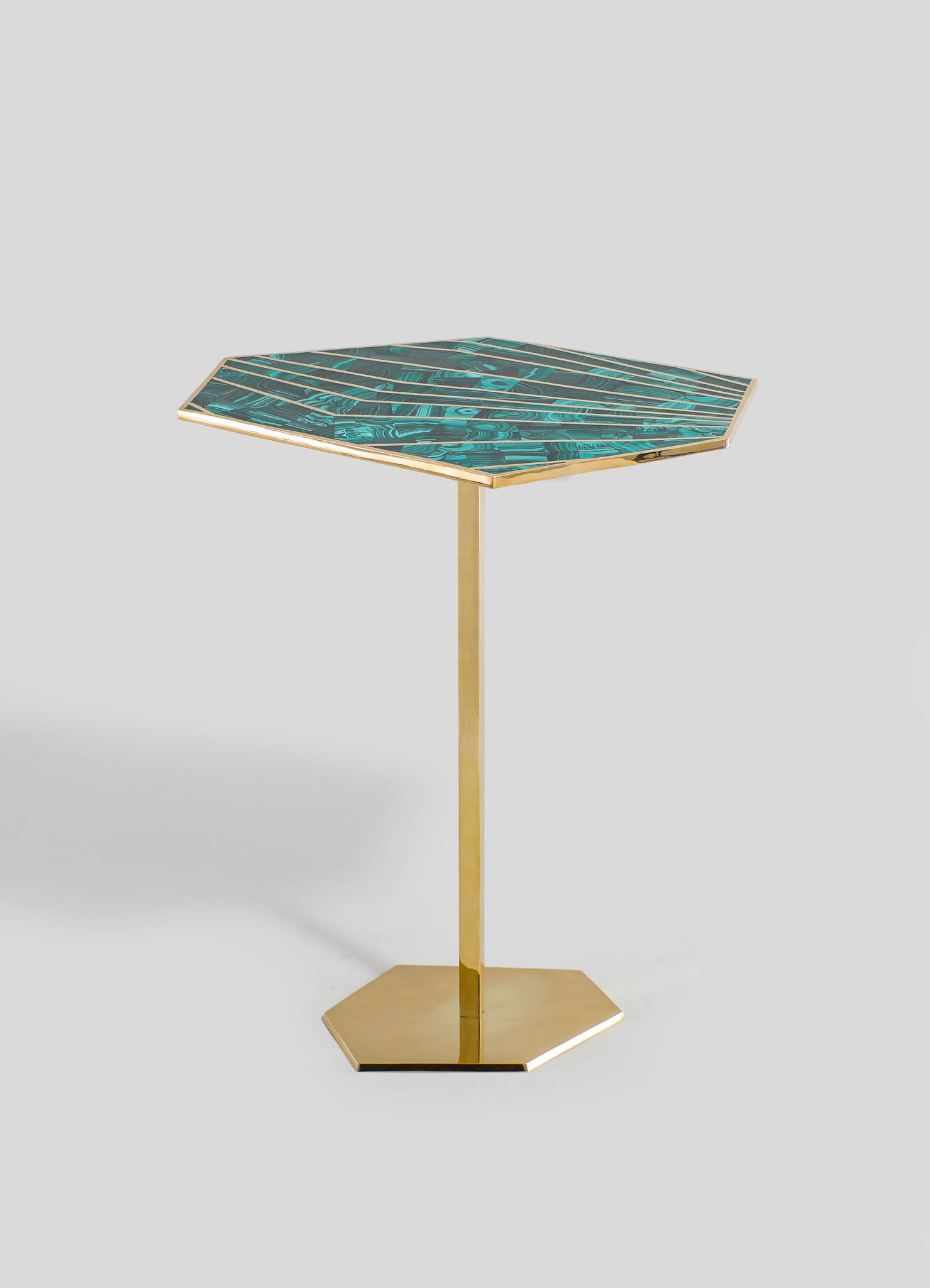 A side table with a square top featuring a turquoise and black marbled pattern, framed by a metallic gold edge, supported by a gold metal pedestal base on a flat hexagonal gold platform.