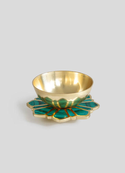 A decorative bowl with a polished gold interior and an exterior featuring green marbled patterns, placed on a matching gold and green patterned tray with a scalloped edge.