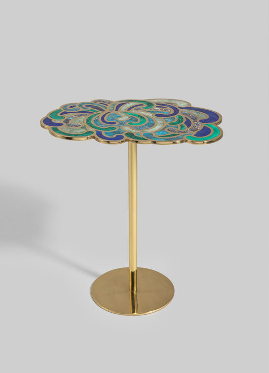 A decorative side table with a floral-shaped top featuring intricate mosaic patterns in shades of blue, green, and beige, framed with a gold metal edge. The table has a slender gold metal stem and a round gold base, combining contemporary design with artisanal craftsmanship.