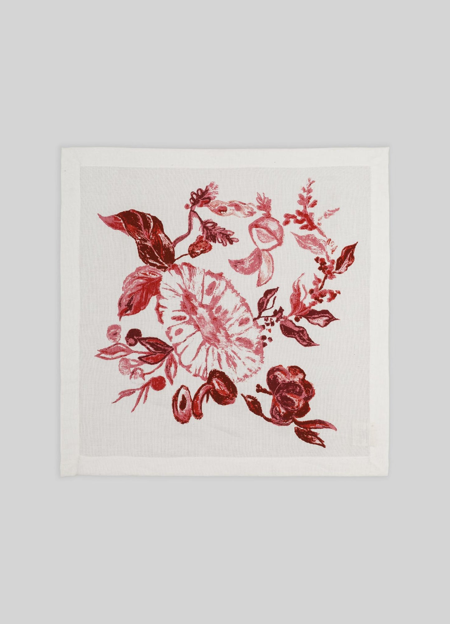 A white fabric napkin with a red floral print featuring leaves, roses, and other botanical motifs. The design has a hand-drawn, painterly style suitable for elegant table settings.