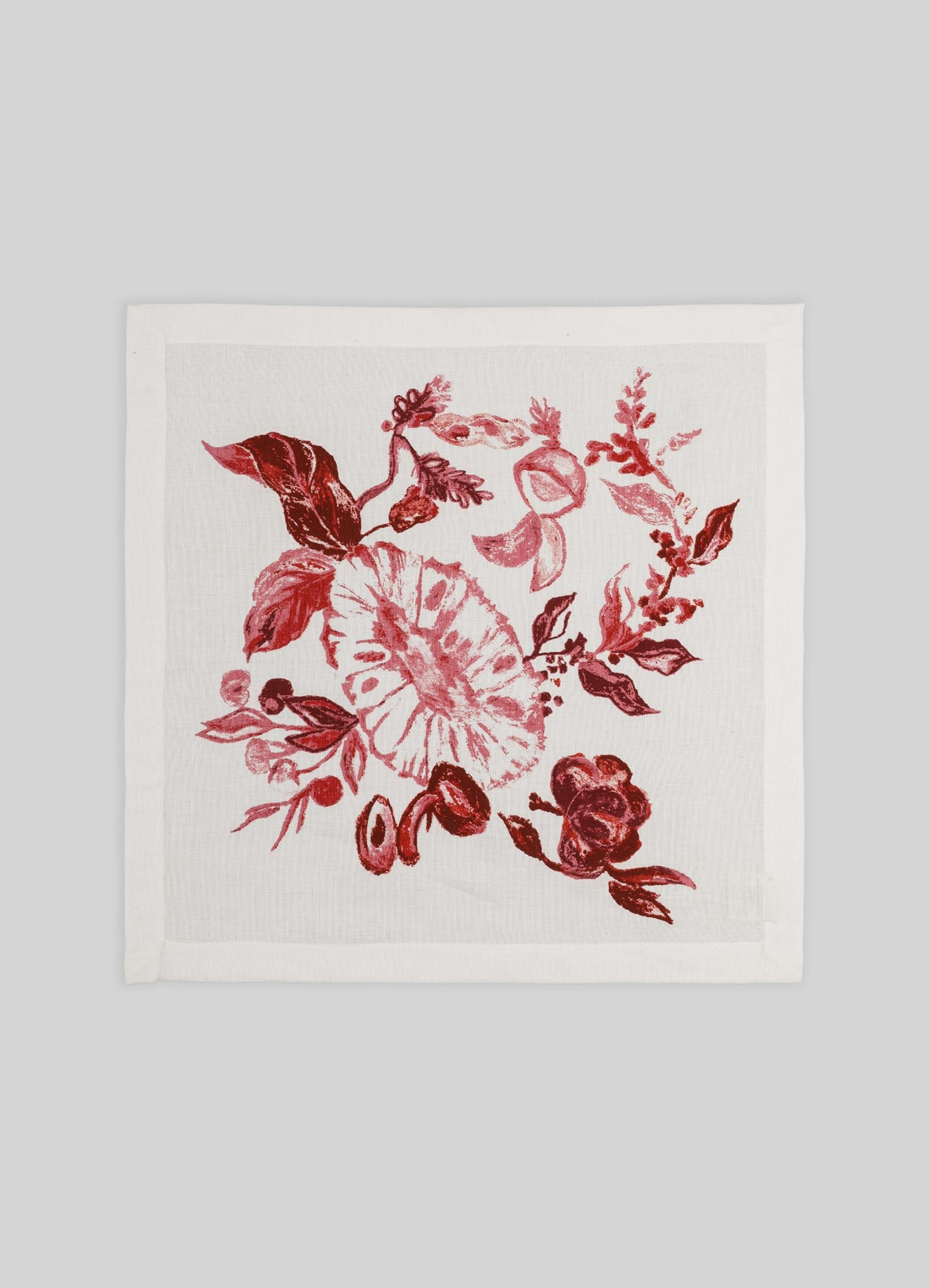 A white fabric napkin with a red floral print featuring leaves, roses, and other botanical motifs. The design has a hand-drawn, painterly style suitable for elegant table settings.