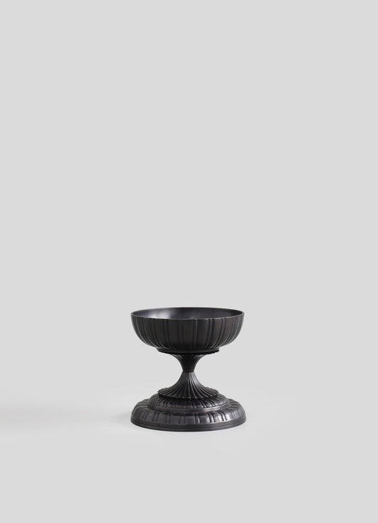 Black metal pedestal bowl with a ribbed, fluted design and a circular base, featuring a matte finish.