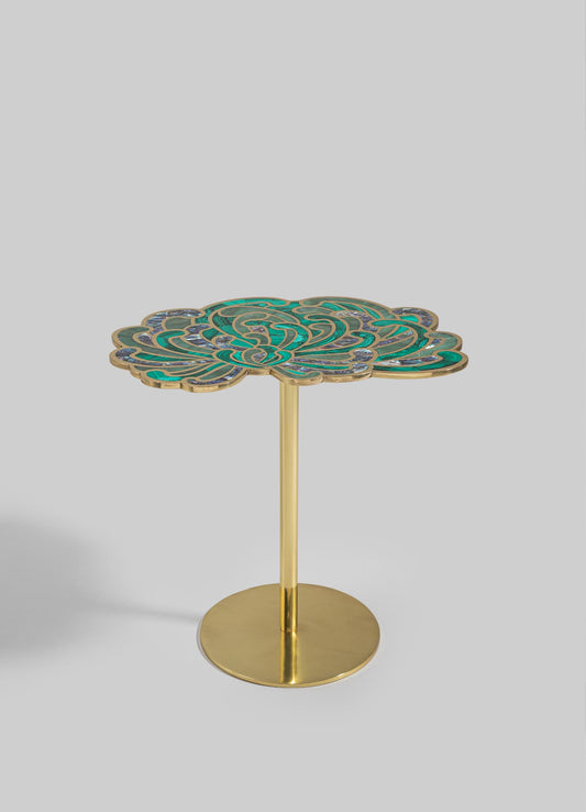 A side table with a circular brass base and a decorative top featuring an intricate, swirling pattern in shades of turquoise, green, and purple. The table combines a contemporary style with an artistic, handcrafted motif.