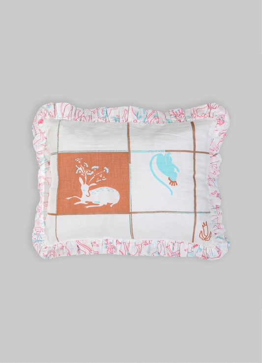 Cotton decorative cushion with a patchwork design featuring stylized floral and animal motifs in pastel blue and terracotta on a white background, edged with a ruffled floral print border.