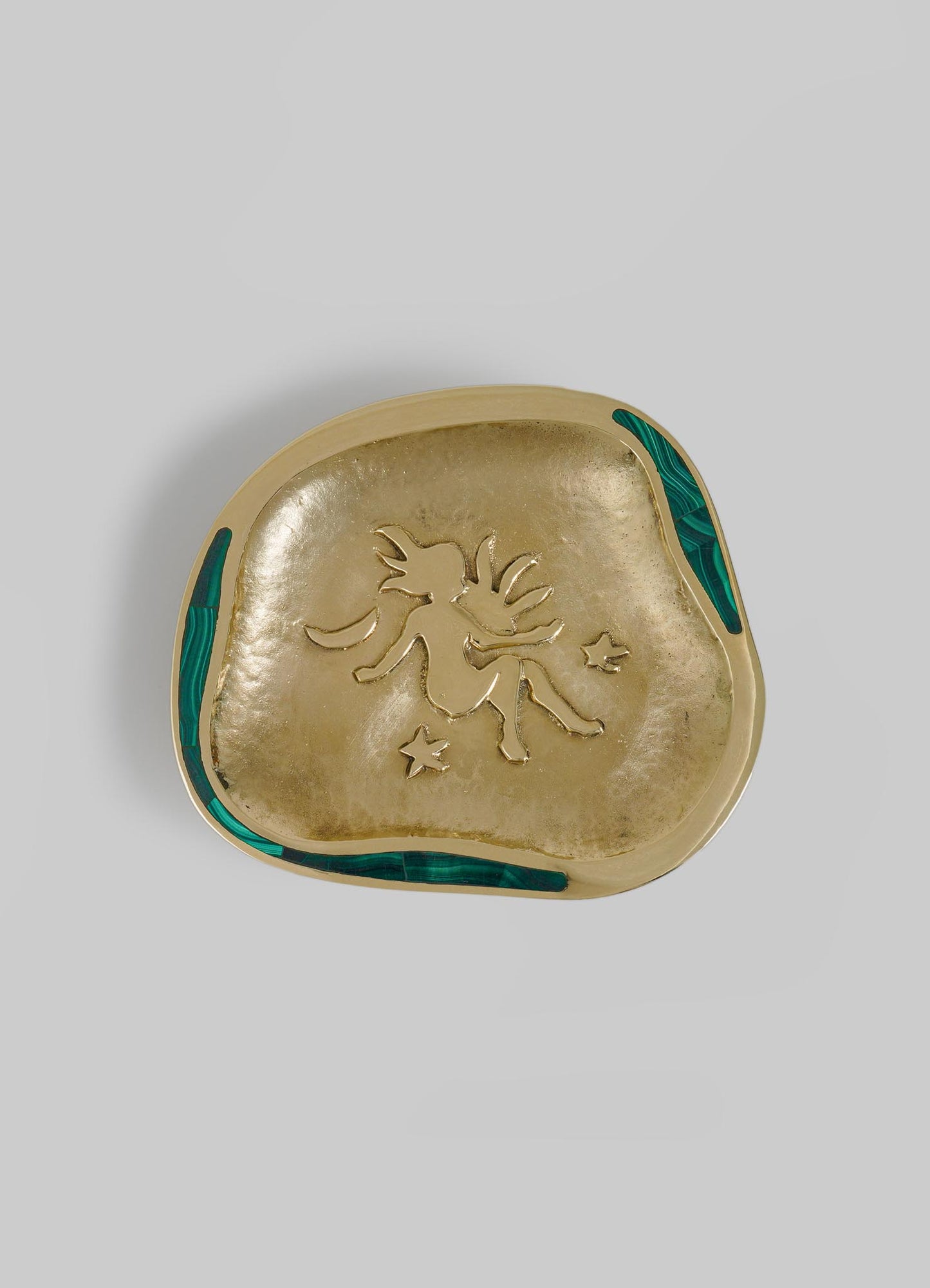 A decorative ceramic dish featuring a gold-toned interior with an embossed dragon motif and star accents, framed by a beige border with green geometric inlay details.
