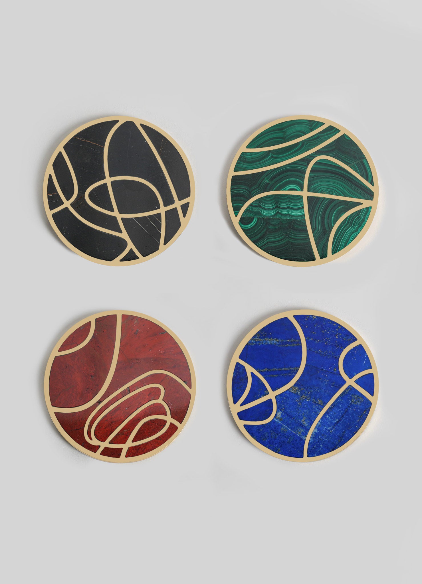 Set of four round wall decor pieces with abstract patterns and bold colors, featuring black, green, red, and blue hues. Each piece has a beige border and a textured surface, combining contemporary style with artistic motifs.