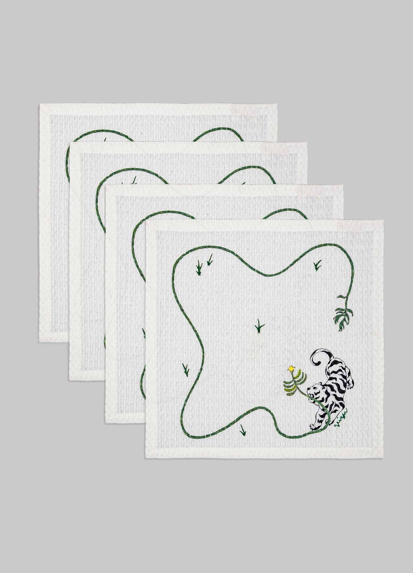 Set of four white tea towels with embroidered black and green tiger motif and green vine-like border design, made of cotton or linen.