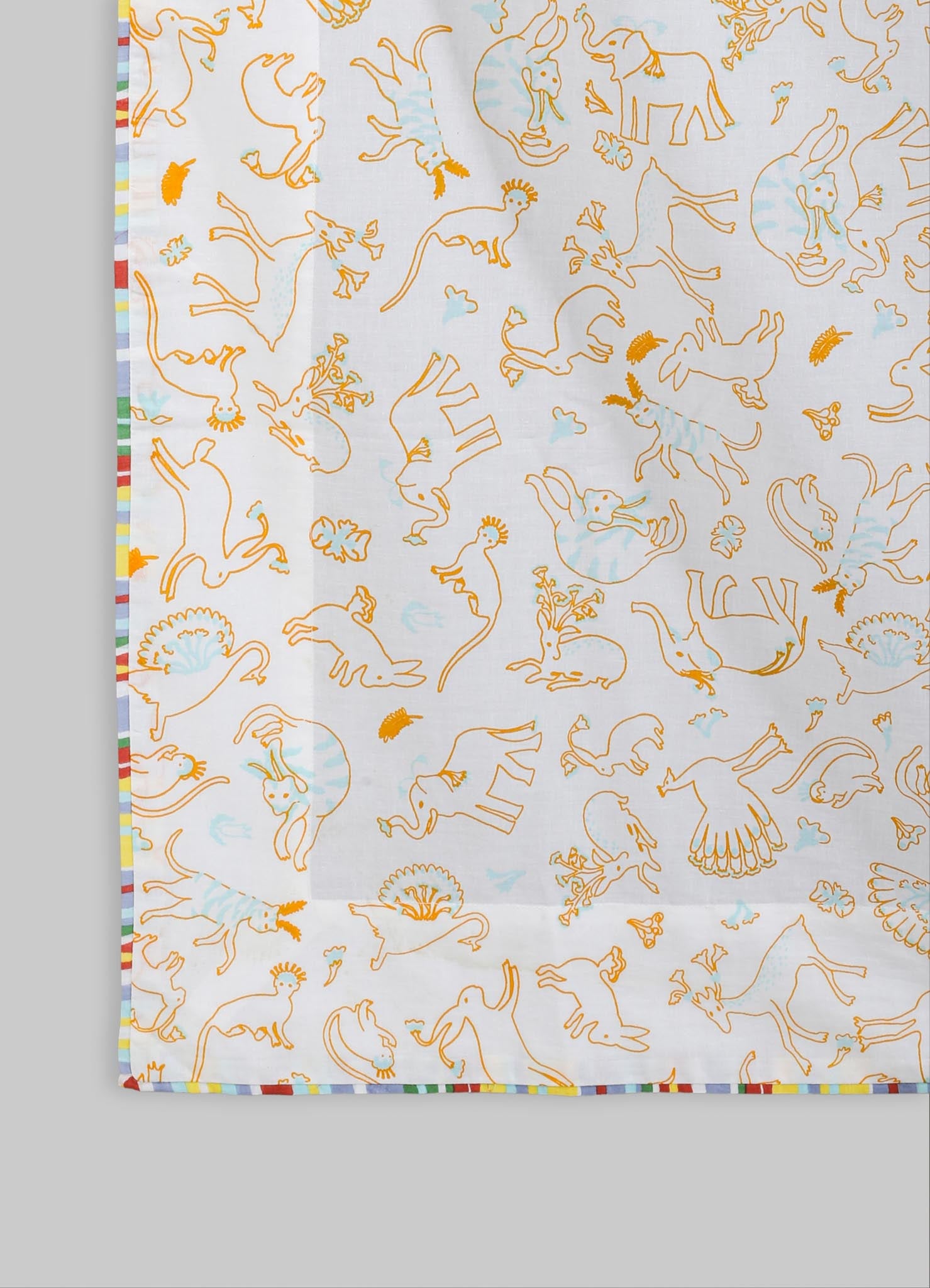 A lightweight, white fabric with a playful print of orange-outlined animal motifs, including elephants, lions, and birds, accented by small blue details. The fabric features a colorful striped border along one edge.