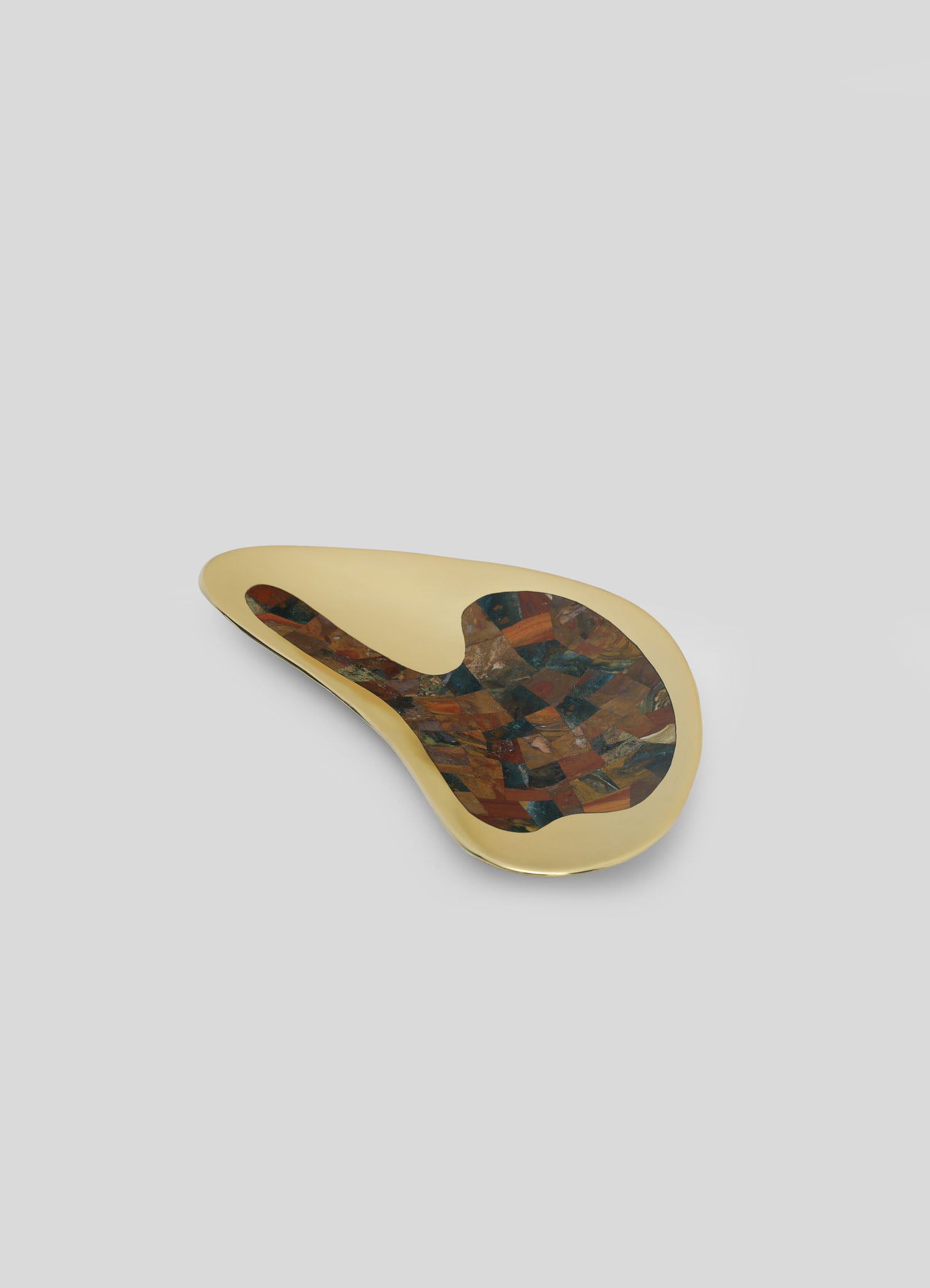 A decorative tray with a teardrop shape, featuring a gold-colored border and an interior mosaic of multicolored tiles in warm earthy tones. The tray has a smooth, glossy finish with a contemporary and artisanal style.