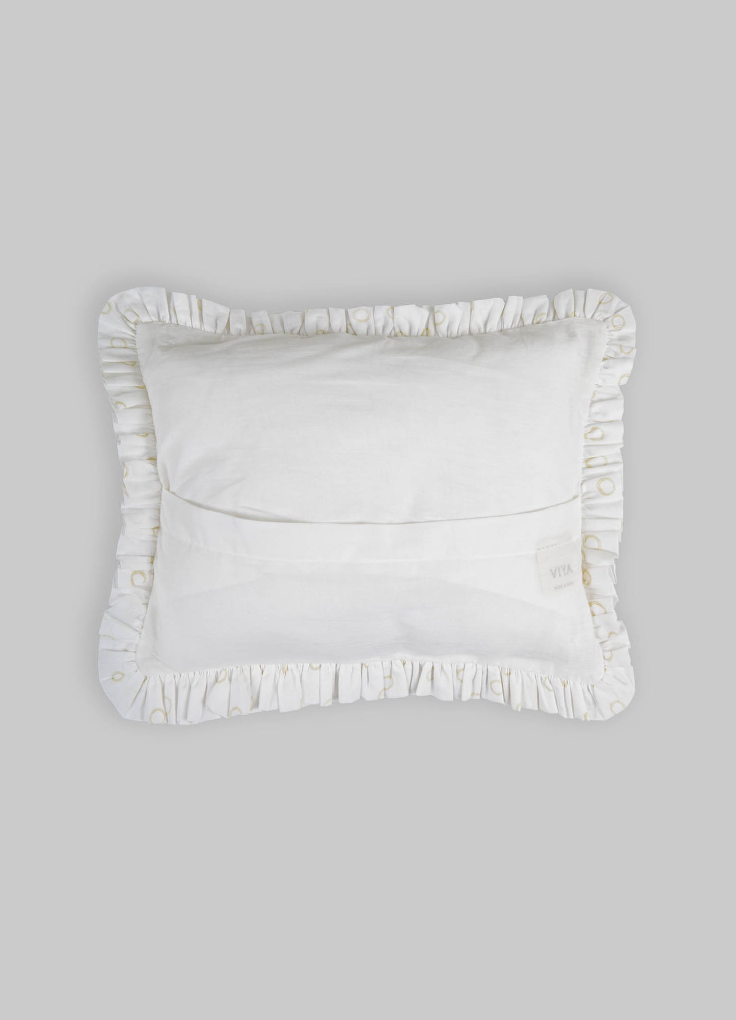 A white decorative pillow with ruffled edges featuring subtle gold embroidery, made from soft fabric with a plush filling.