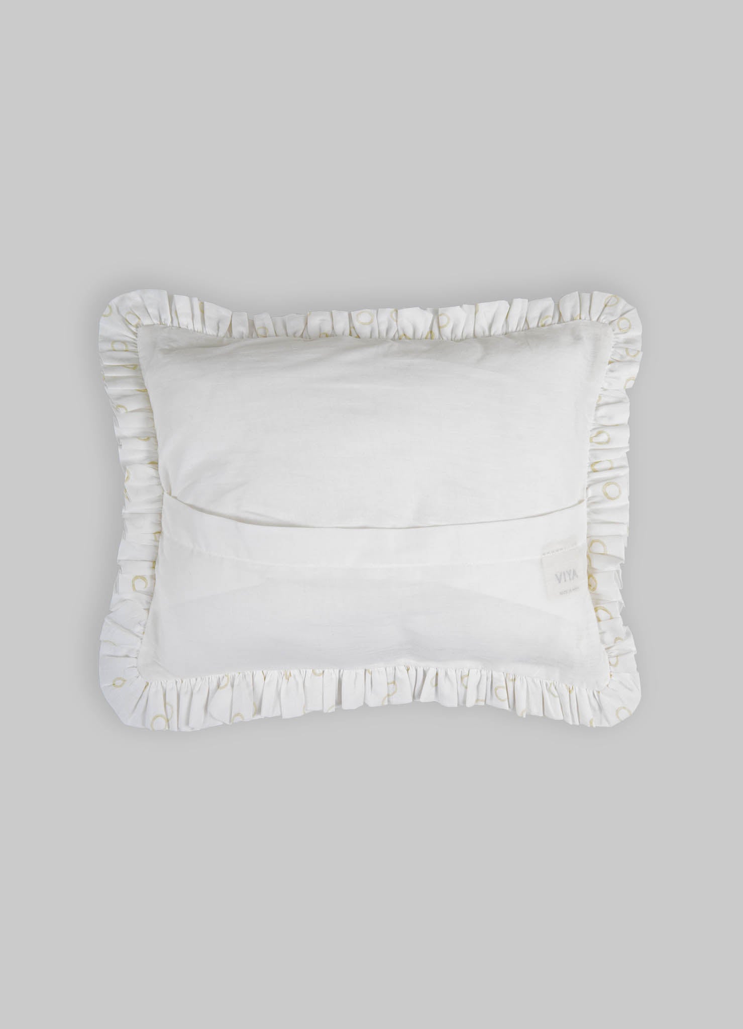 A white decorative pillow with ruffled edges featuring subtle gold embroidery, made from soft fabric with a plush filling.