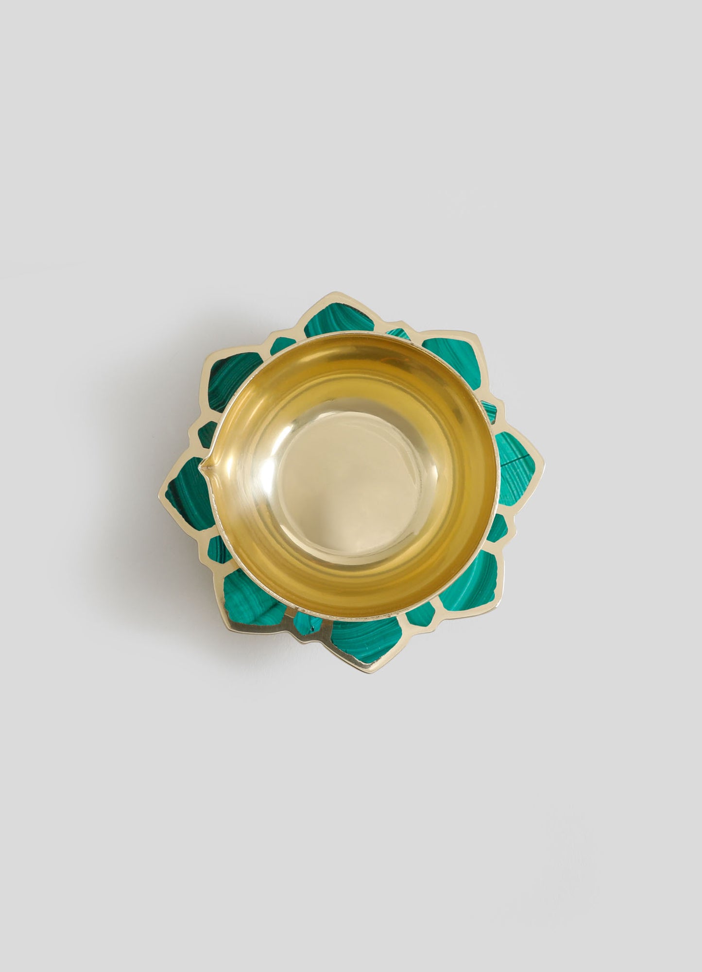 A decorative dish with a gold interior and teal, geometric-patterned border made of shell or stone inlay. The design combines a luxurious metallic finish with a handcrafted, artisanal style.