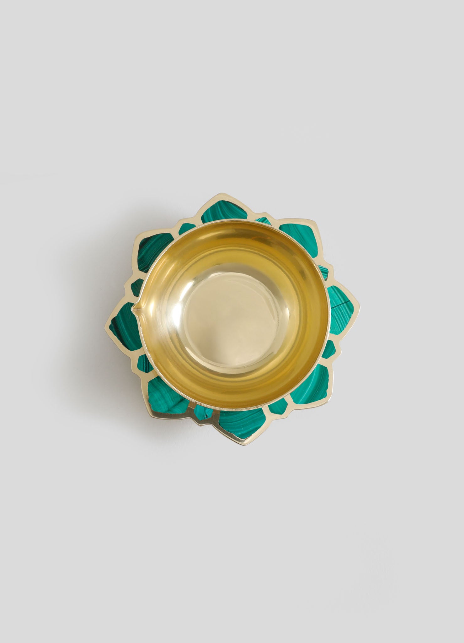 A decorative dish with a gold interior and teal, geometric-patterned border made of shell or stone inlay. The design combines a luxurious metallic finish with a handcrafted, artisanal style.