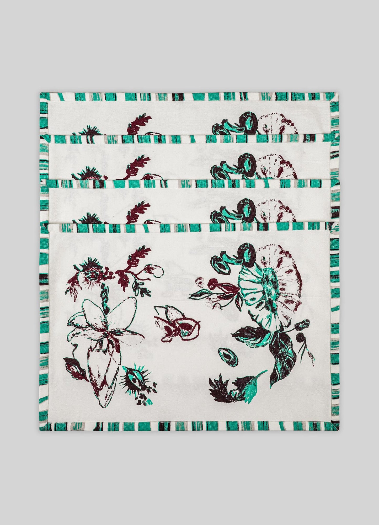 Fabric placemats with a floral and butterfly motif, featuring a striped border in shades of teal, black, and white. Made of lightweight fabric suitable for dining table decor.