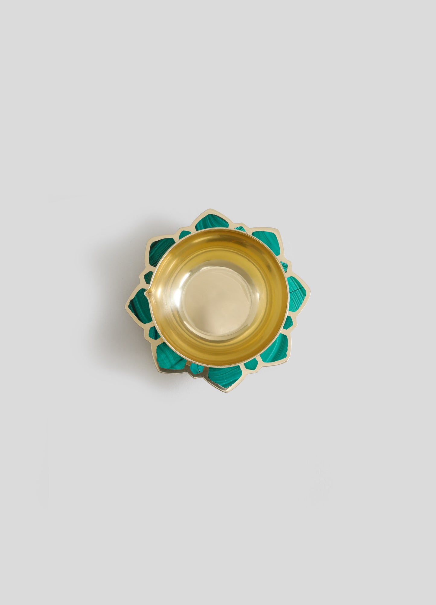 Ceramic bowl with a gold interior and a scalloped edge decorated with teal and cream geometric patterns. The design combines modern and handcrafted styles with bold colors and intricate motifs.