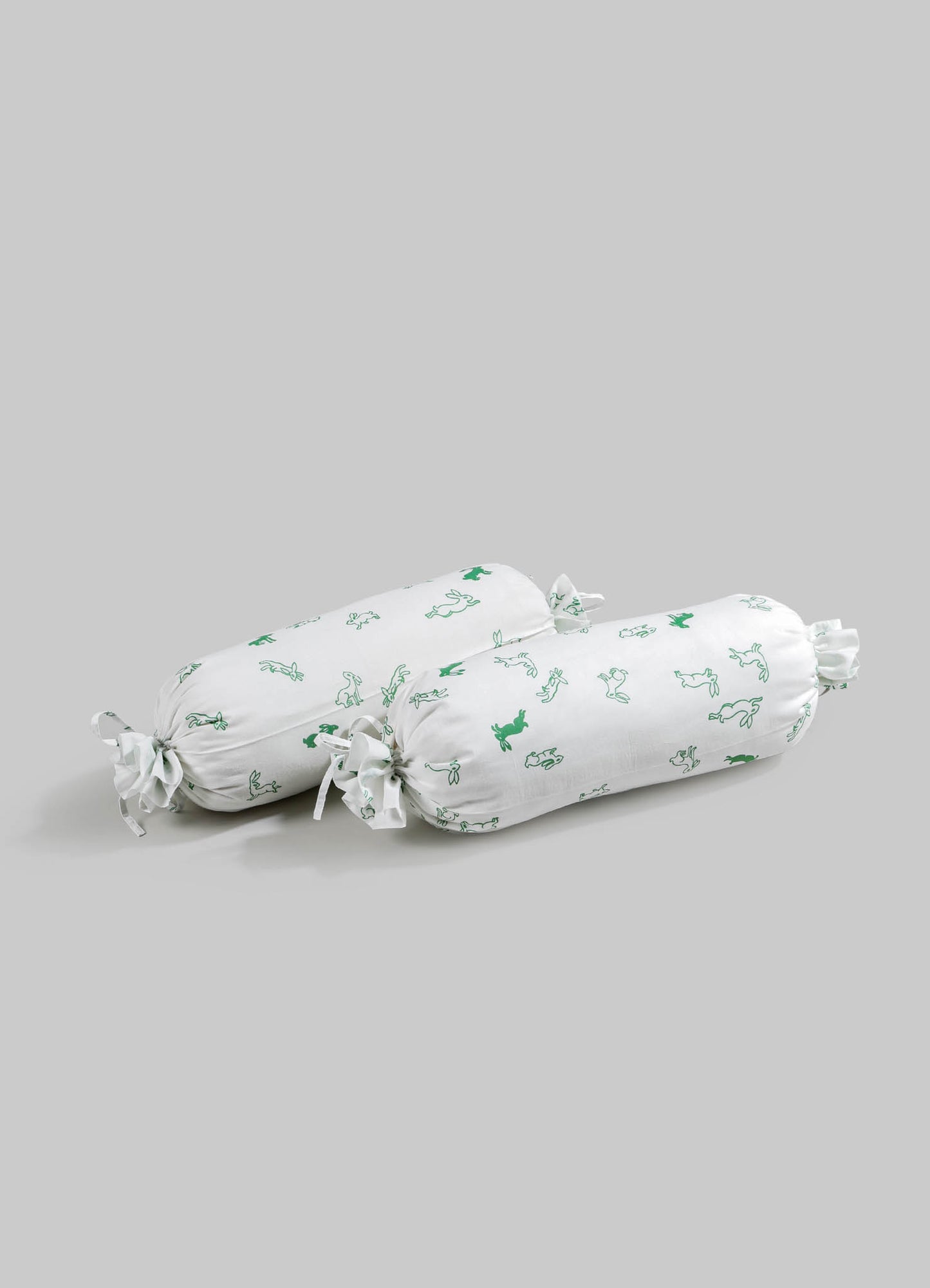 Pair of fabric drawer or cushion covers with a white background and green animal motifs, tied with fabric bows at each end. Made of soft material, suitable for storage or decorative purposes.