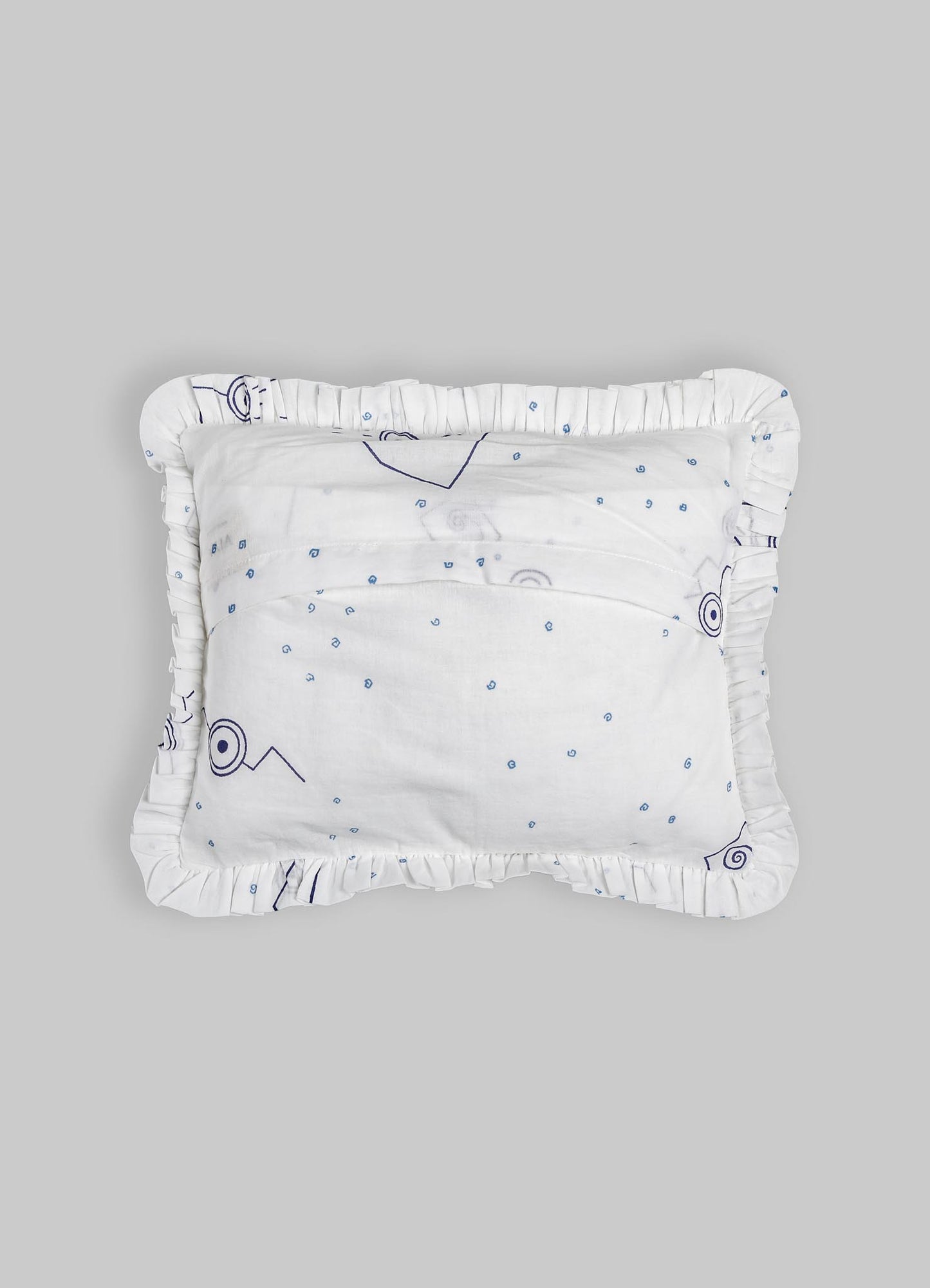 White textile cushion with a ruffled edge and a subtle abstract pattern in navy blue, featuring small circular and line motifs on soft fabric. The cushion has a crafted, handcrafted style with a minimalist and contemporary design.