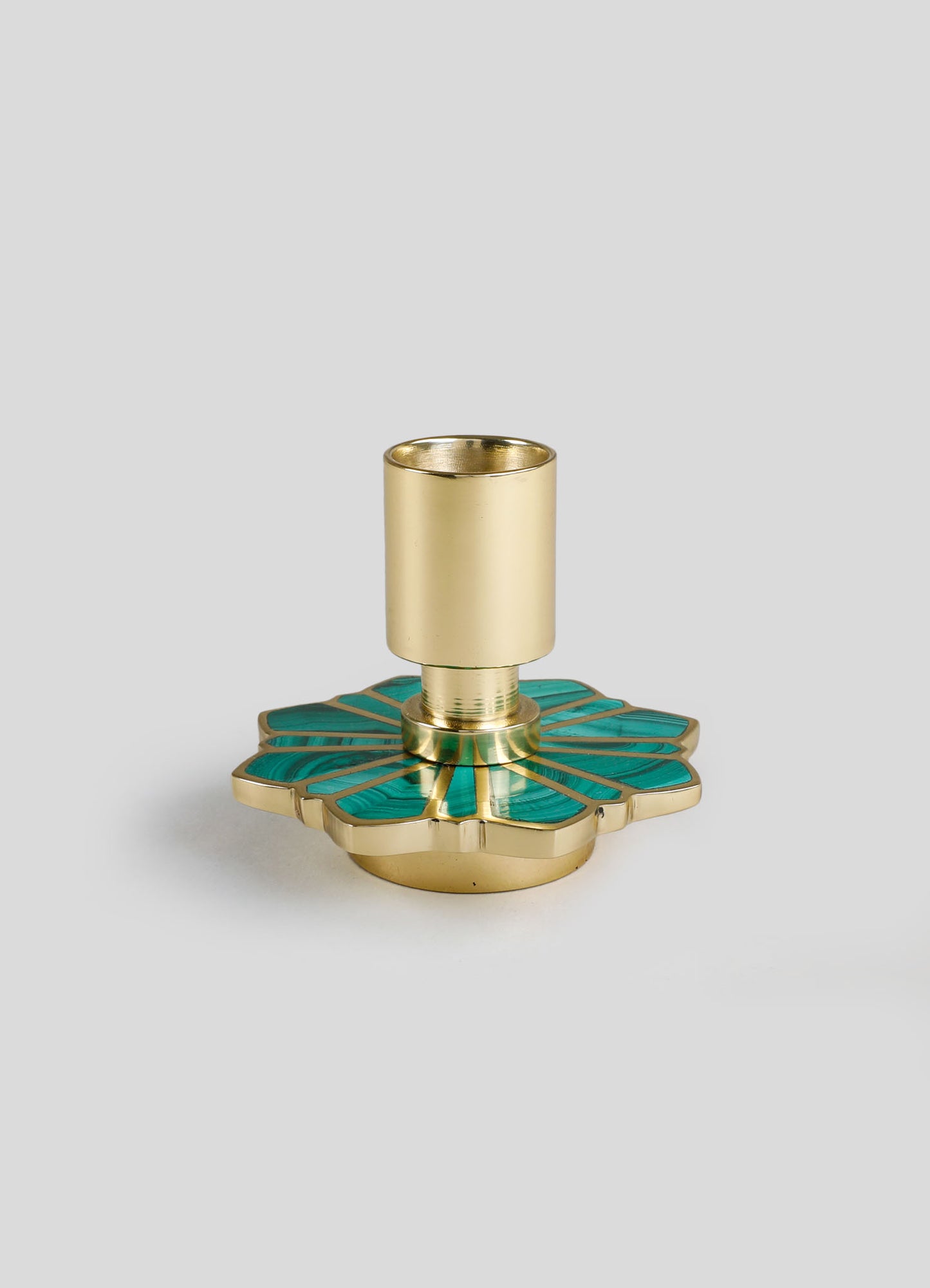 A decorative candle holder with a gold metallic base and a cylindrical gold candle cup on top, featuring a large, flower-shaped turquoise and gold inlay design.