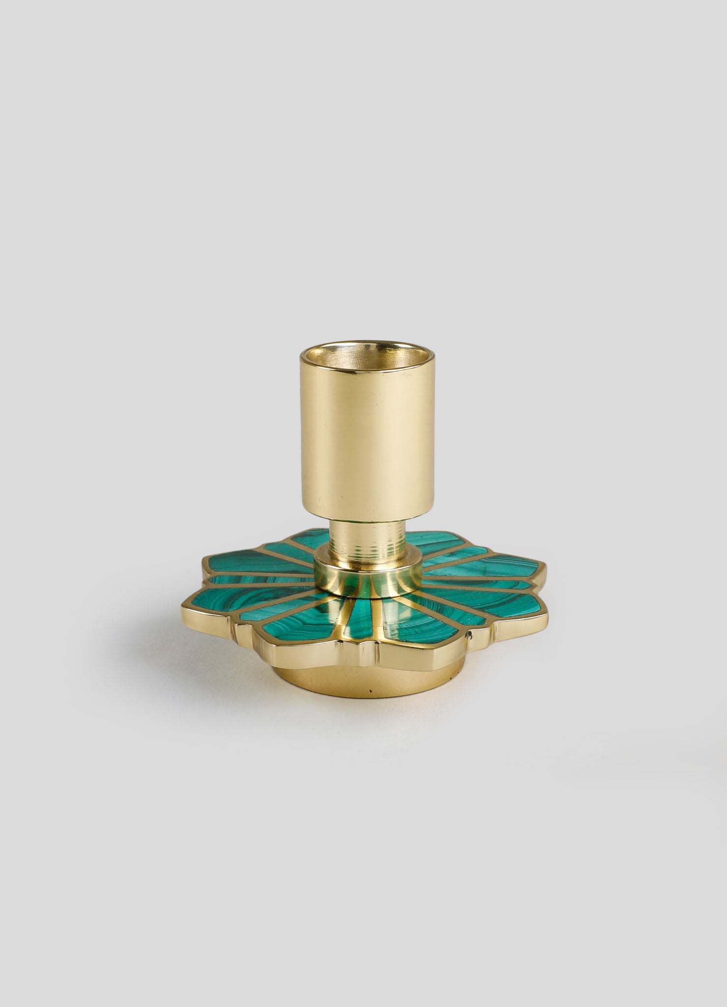A decorative candle holder with a gold metallic base and a cylindrical gold candle cup on top, featuring a large, flower-shaped turquoise and gold inlay design.