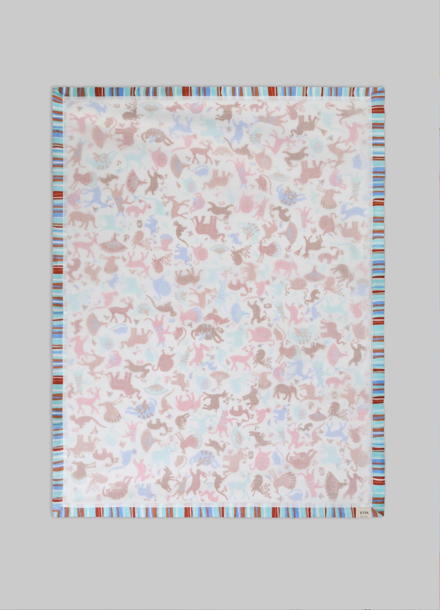A lightweight cotton or linen scarf with a pastel-colored animal motif print in shades of pink, blue, and beige, bordered by multicolored stripes in red, blue, and white, on a neutral background.
