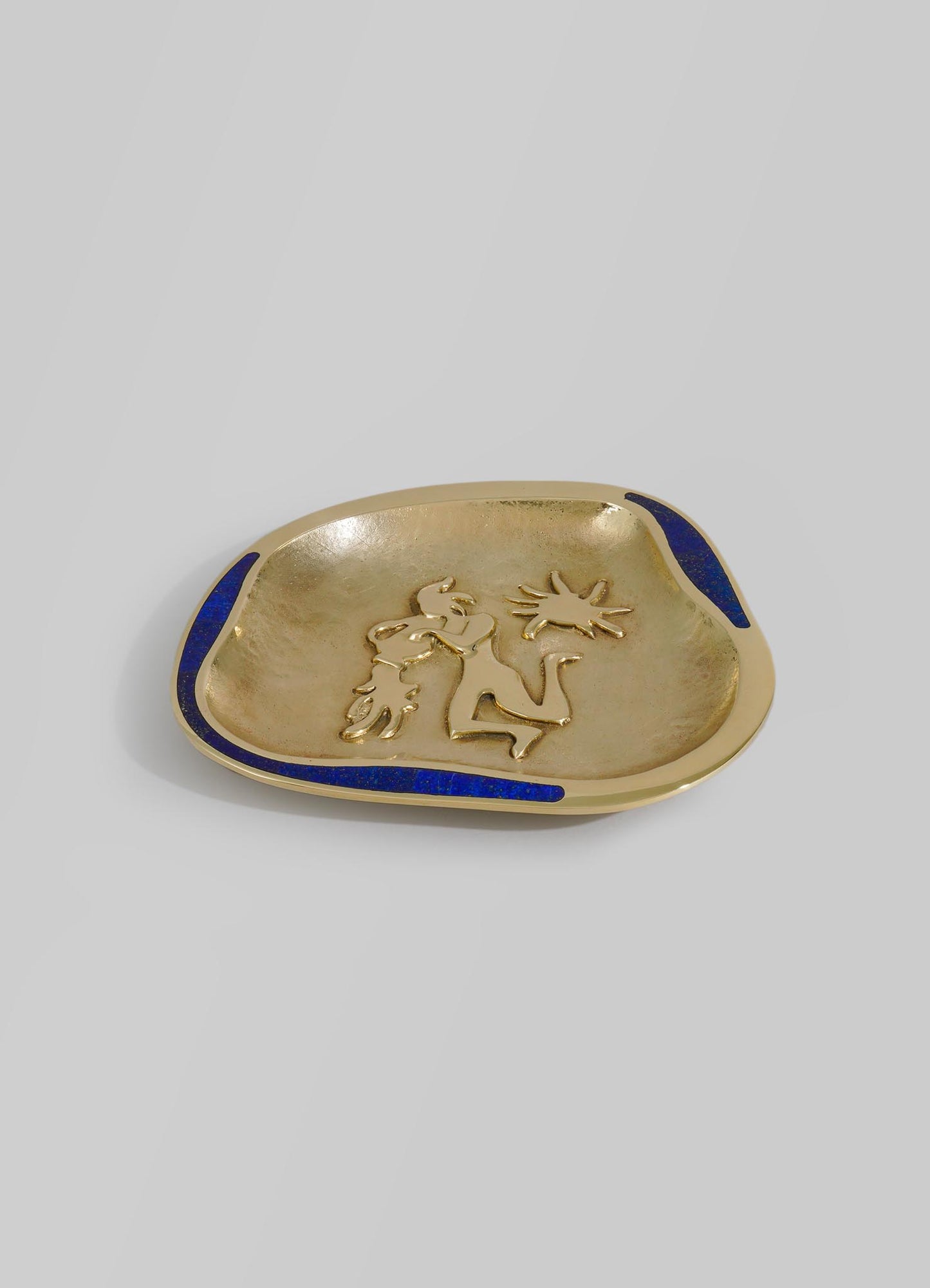 A decorative ceramic dish with a gold finish, featuring a raised motif of a dragon and blue accents along the edges, in a modern artisanal style.