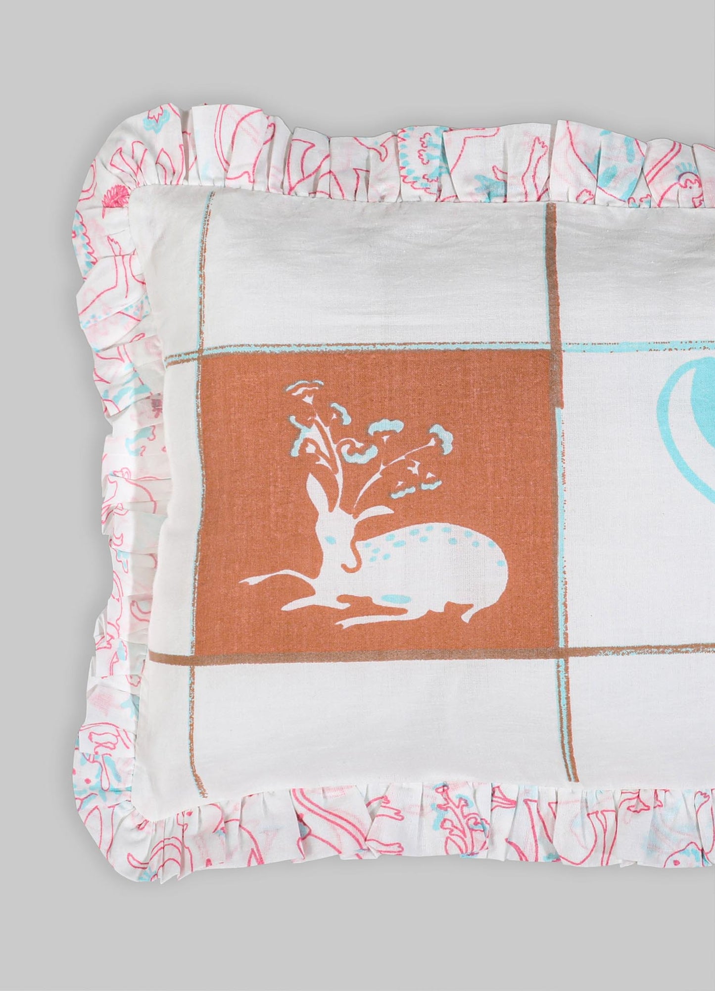 Decorative pillow with a printed textile featuring a stylized animal motif and floral illustration, bordered by ruffled fabric with abstract line art in pink and blue tones.