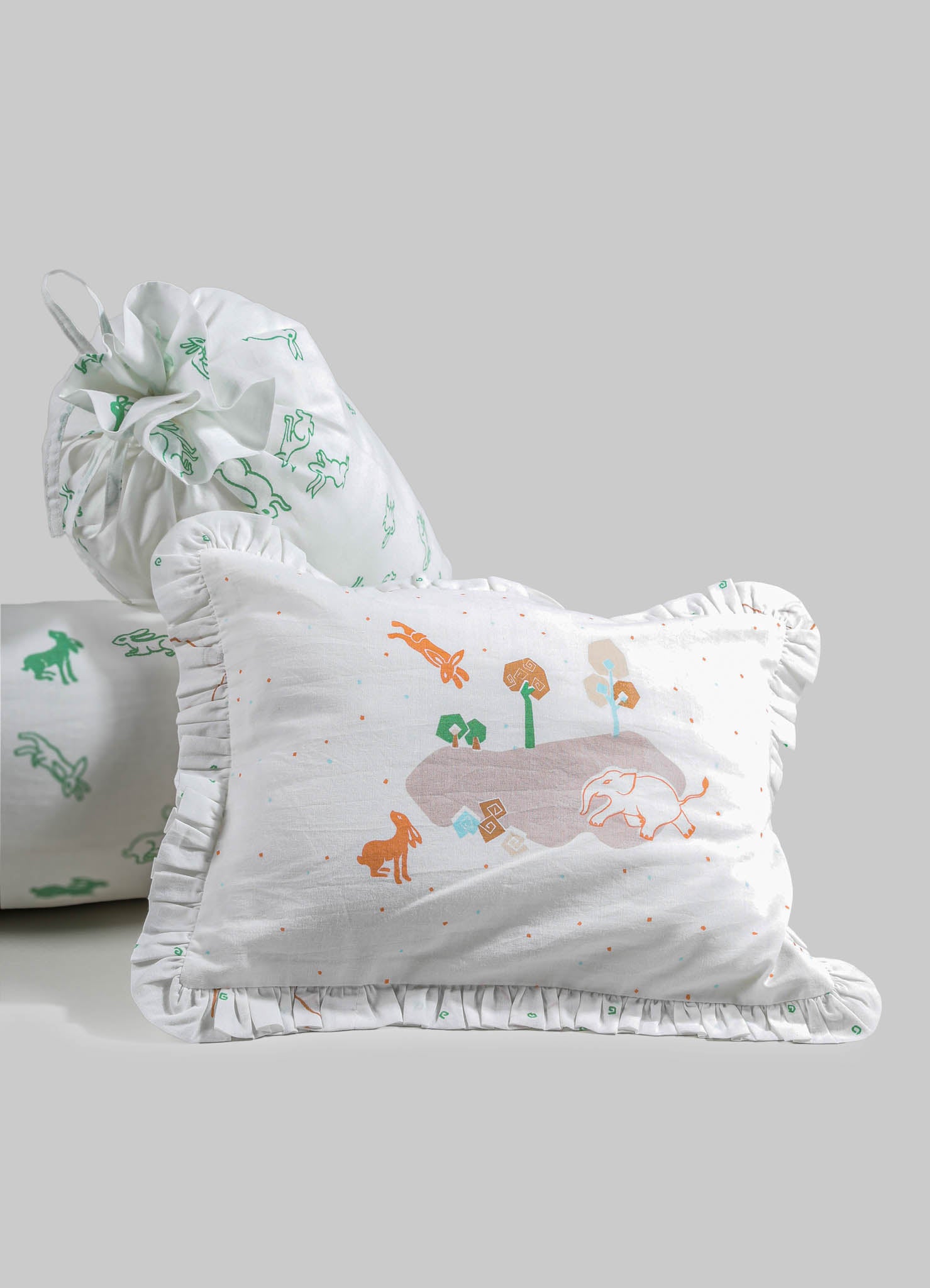 Cotton pillowcases with ruffled edges, featuring playful animal and nature motifs in pastel colors on a white background. The fabric appears lightweight and soft, designed for children's bedding or decorative use.