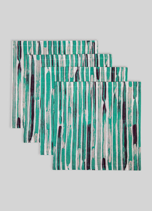 Set of three fabric placemats featuring an abstract vertical stripe pattern in shades of teal, black, and white, made from a smooth material with cleanly finished edges.