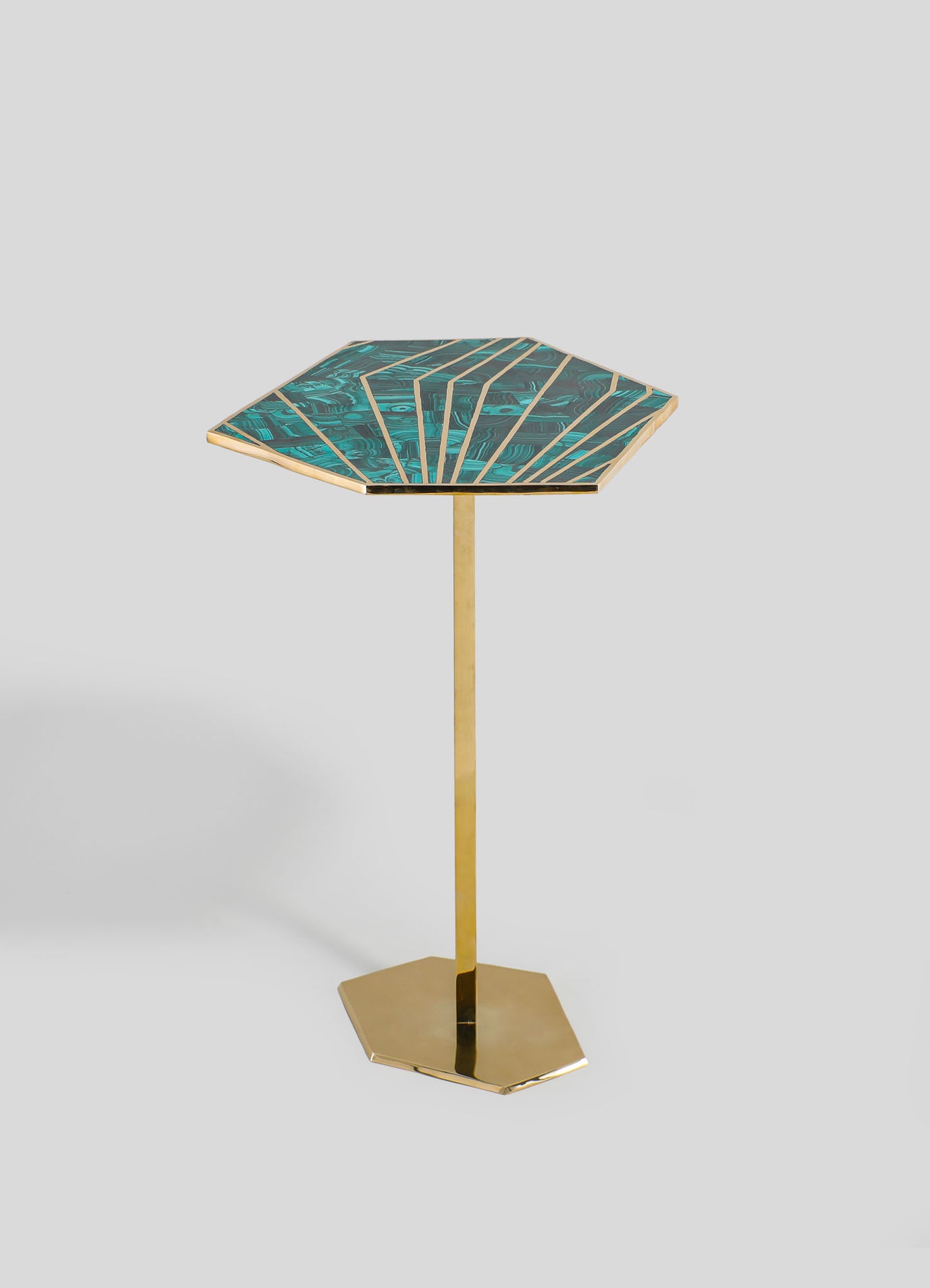 A side table with a hexagonal top featuring a blue and green marbled pattern with gold accents, supported by a sleek, gold-finished pedestal base.